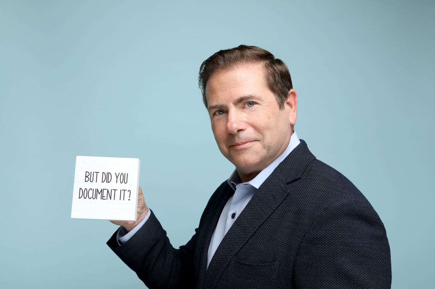 Aaron Weaver holding a card that reads: But did you document it?